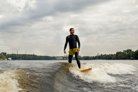 Man surfing on a wakeboard on a river