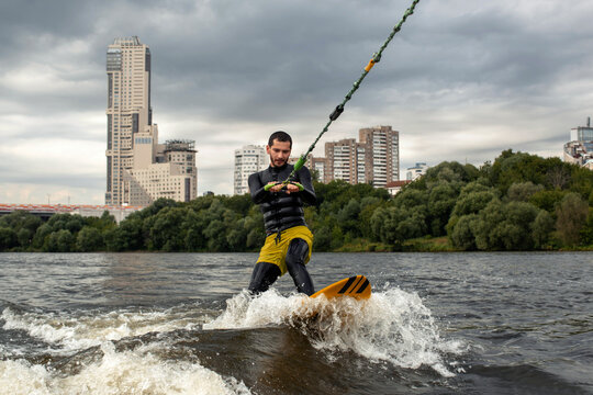 Man surfing on a wakeboard on a river