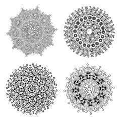 Vector monochrome set of mandalas. Decorative circular ornaments. Four round abstract objects isolated on white background.