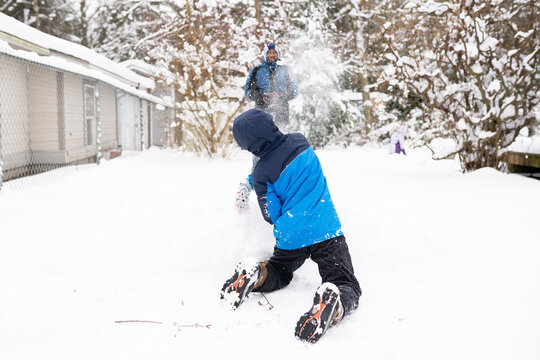 Father and son have snowball fight 