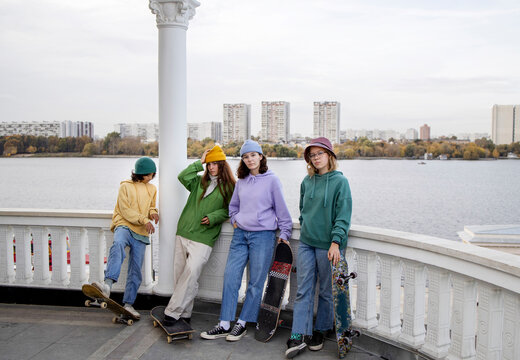 Four girls skateboarders outdoors