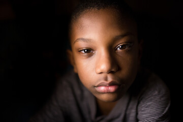High contrast portrait of a serious young boy