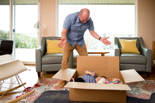 Father acts surprised to find his children curled in a box