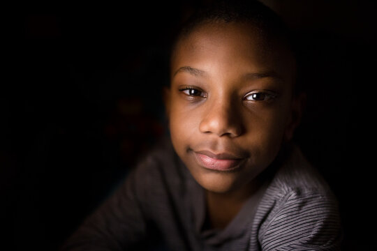 Young black boy smiles at viewer