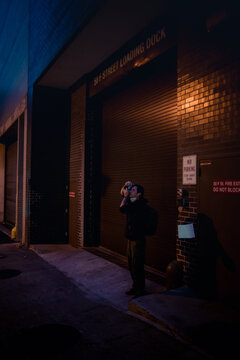 Photographer shooting in a dark alley