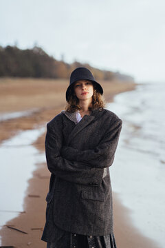 attractive warmly dressed girl walking by the sea

