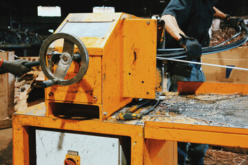 Workers at a Recycling Factory Using A Machine For Metal