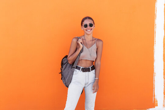 Stylish woman with backpack on street