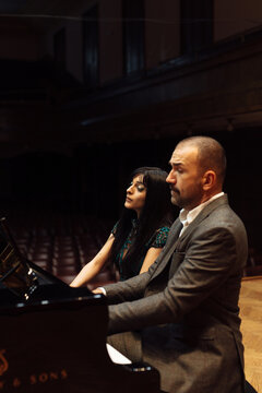 Man and woman, playing a piano