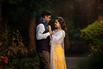 Happy attractive young couple hugging in forest