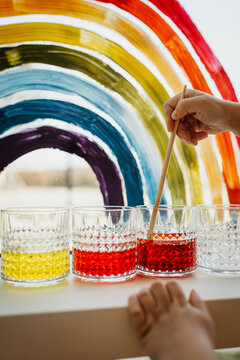 Mixing food coloring in water to make new colors