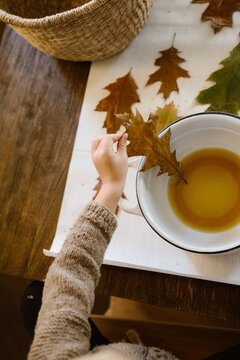 Toddler dipping leaves in melted bees wax