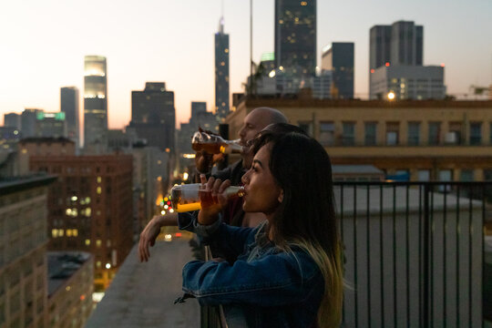 Friends Watch the Sunset and Drink