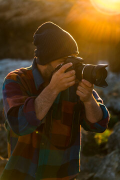 Male photographer taking pictures in nature 