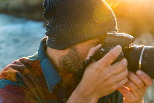 Adventure photographer taking pictures seacliff