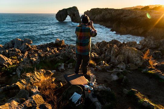 Photographer taking pictures in natureat sunrise