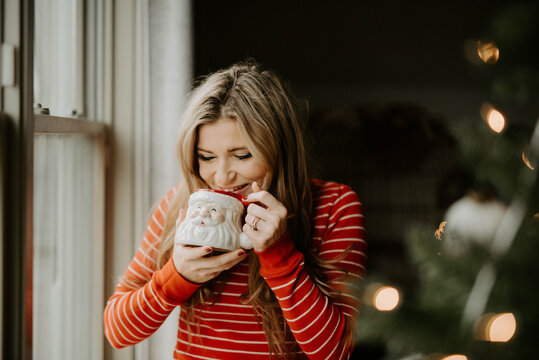 A Woman Decorating Her Apartment For Christmas With Her Pets