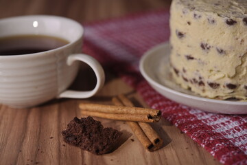Cinnamon sticks, brownie slice cake, and a cup of coffee.
