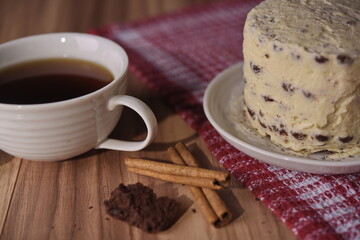 Cinnamon sticks, brownie slice cake, and a cup of coffee.