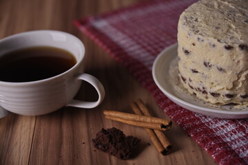 Cinnamon sticks, brownie slice cake, and a cup of coffee.