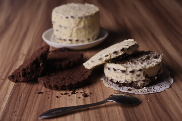 Brownie slices and buttercream cake and a teaspoon on the table.