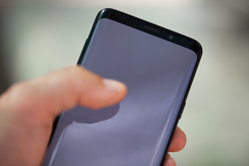 A businessman's hand with a modern phone
