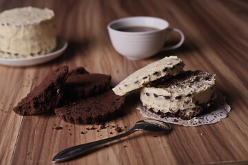Brownie slices and buttercream cake and a teaspoon on the table.