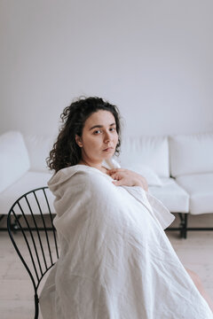Portrait of a young woman in a minimalist interior.