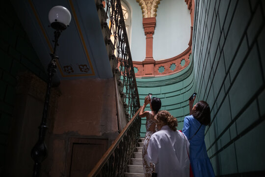 Travelers picturing majestic staircase interior during tour