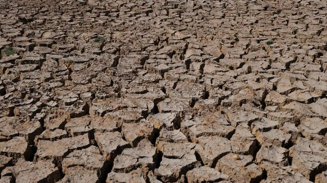 Drought-cracked soils, dry-cracked lakes, drought soil at river bottom. Ecosystems caused by climate change. Drought concept.dried and cracked soils. thirst and desertification. slider dolly shooting