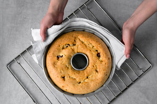 Lemon pie cooking, taking out of the oven. 