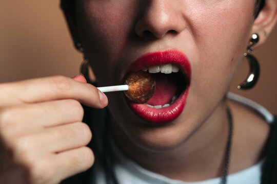 Biting a lollipop