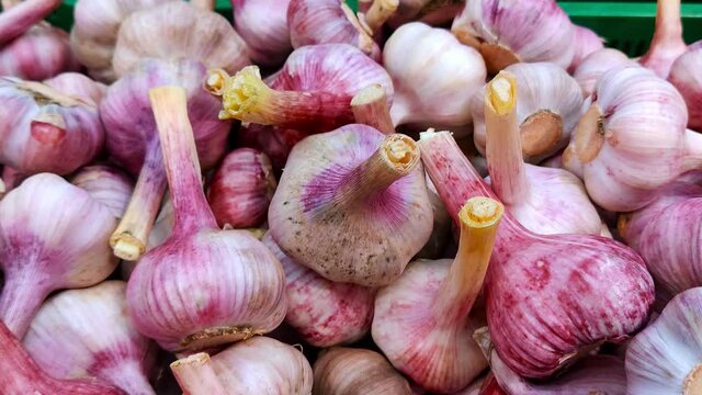 Stack of garlic in grocery store. Industry of selling products