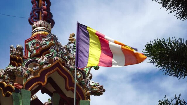 Buddhist flag universal symbol of Buddhism flutter in Giac Nguyen temple Vietnam