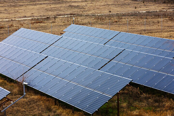 Small solar energy farm on natural meadow in nature. Renewable energy concept.