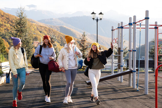 Delighted sportswomen walking on sports ground in highlands