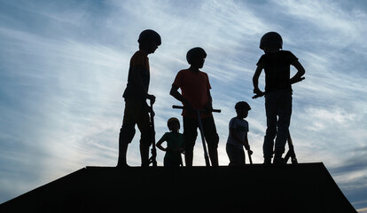 Friends with kick scooters gathering on ramp