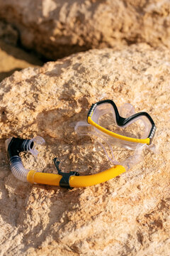 Snorkeling gear on stony seashore