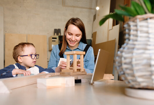 Mom and little kid making woodwork together