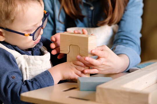 Mother and child making wooden toy together