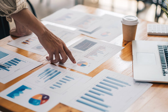 Businessman Discussing Analysis Charts Or Graphs On Desk Table And Using Laptop Computer.Close Up Male Analysis And Strategy Concept.