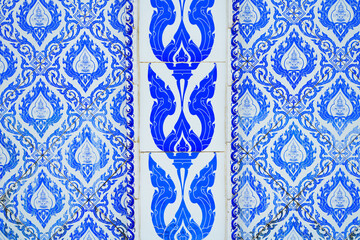 wall of the church is decorated with ceramic tiles with blue Thai pattern.