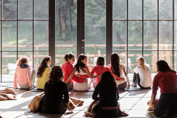 Women hugging and resting yoga studio