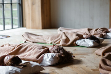 Calm women sleeping during nidra yoga session