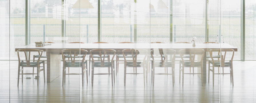 Meeting room with long wooden table, chairs and panoramic window - Powered by Adobe