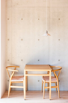 Wooden table with chairs and lamp in coffee shop