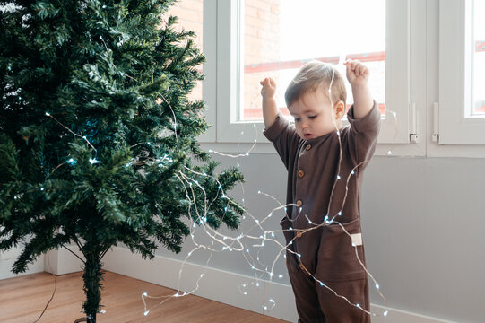 Boy with Christmas string lights