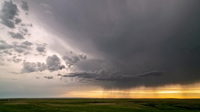 Timelapse of dramatic storm system rolls over the South Dakota plains as it rains in the distance.