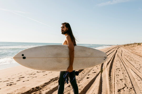 men with surfboard at the beach