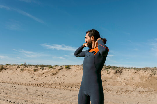 man in diving suit warming up